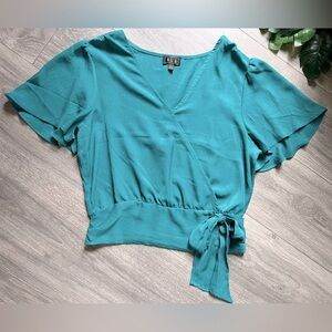 OLM flutter sleeve faux wrap blouse in teal. Size L
